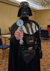 Photo of person wearing a Darth Vader costume and holding a grip strength measuring device